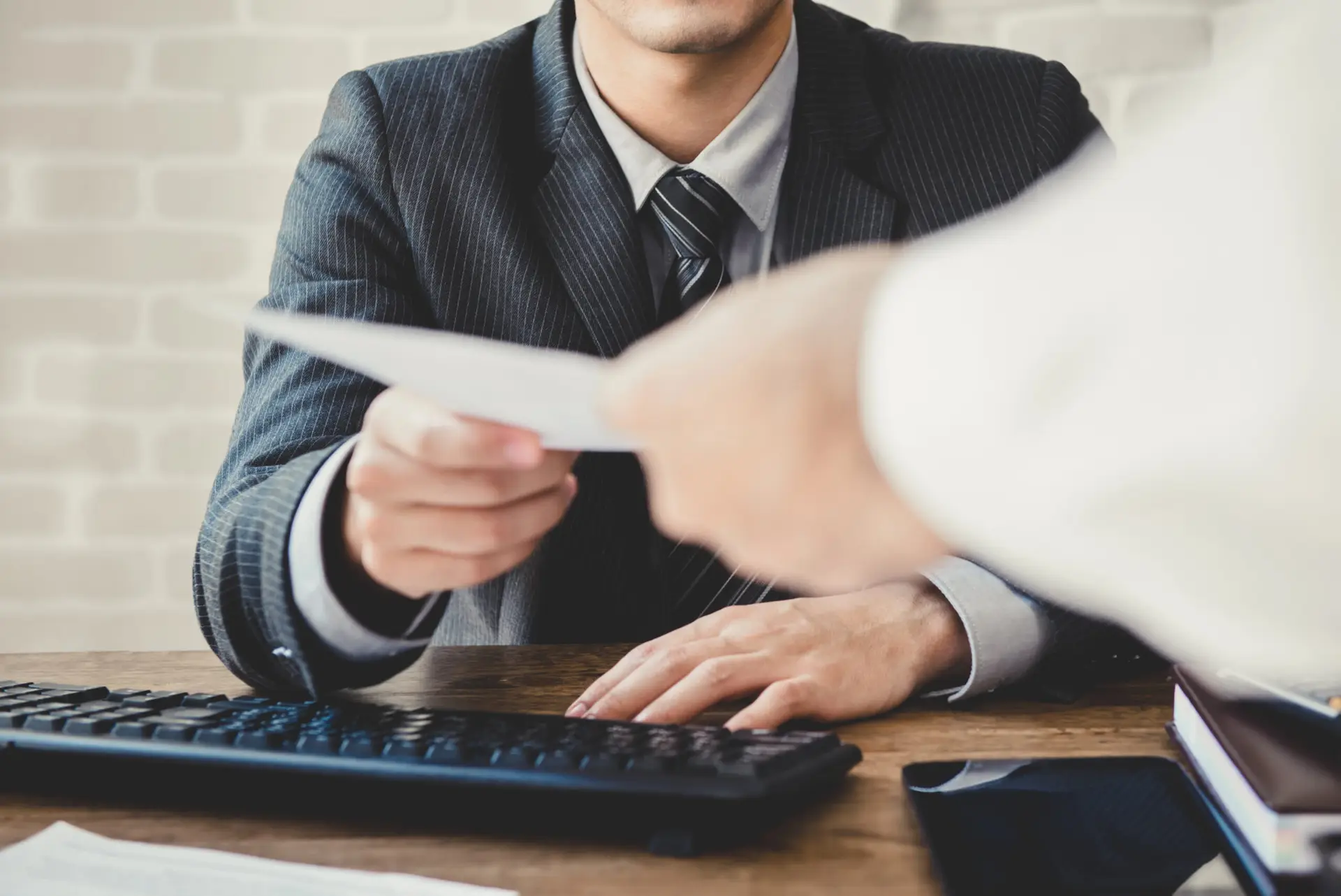 Business professional handing over a document for apostille processing