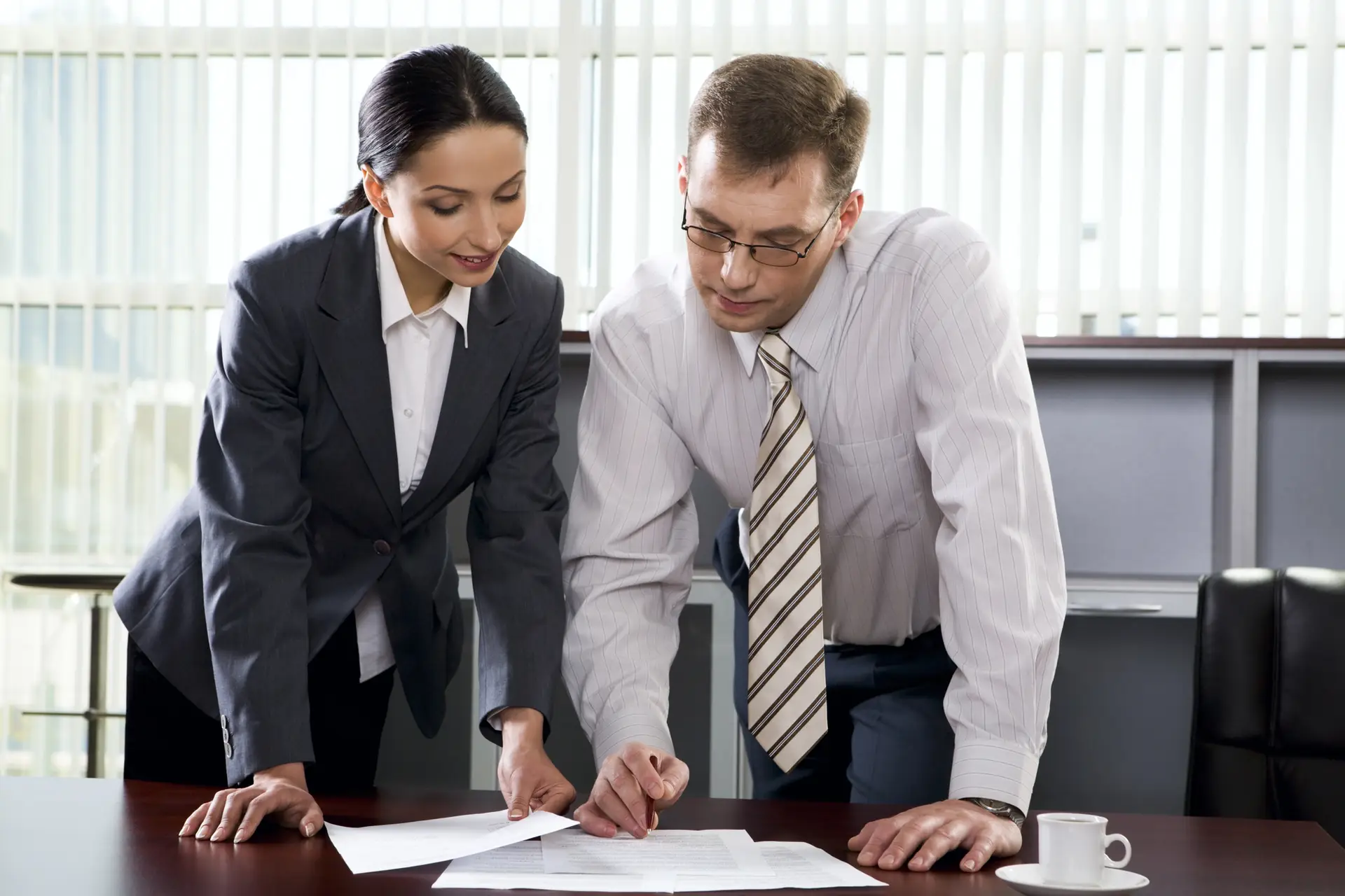 Notary in New Jersey assisting client with signing official loan documents at a professional office