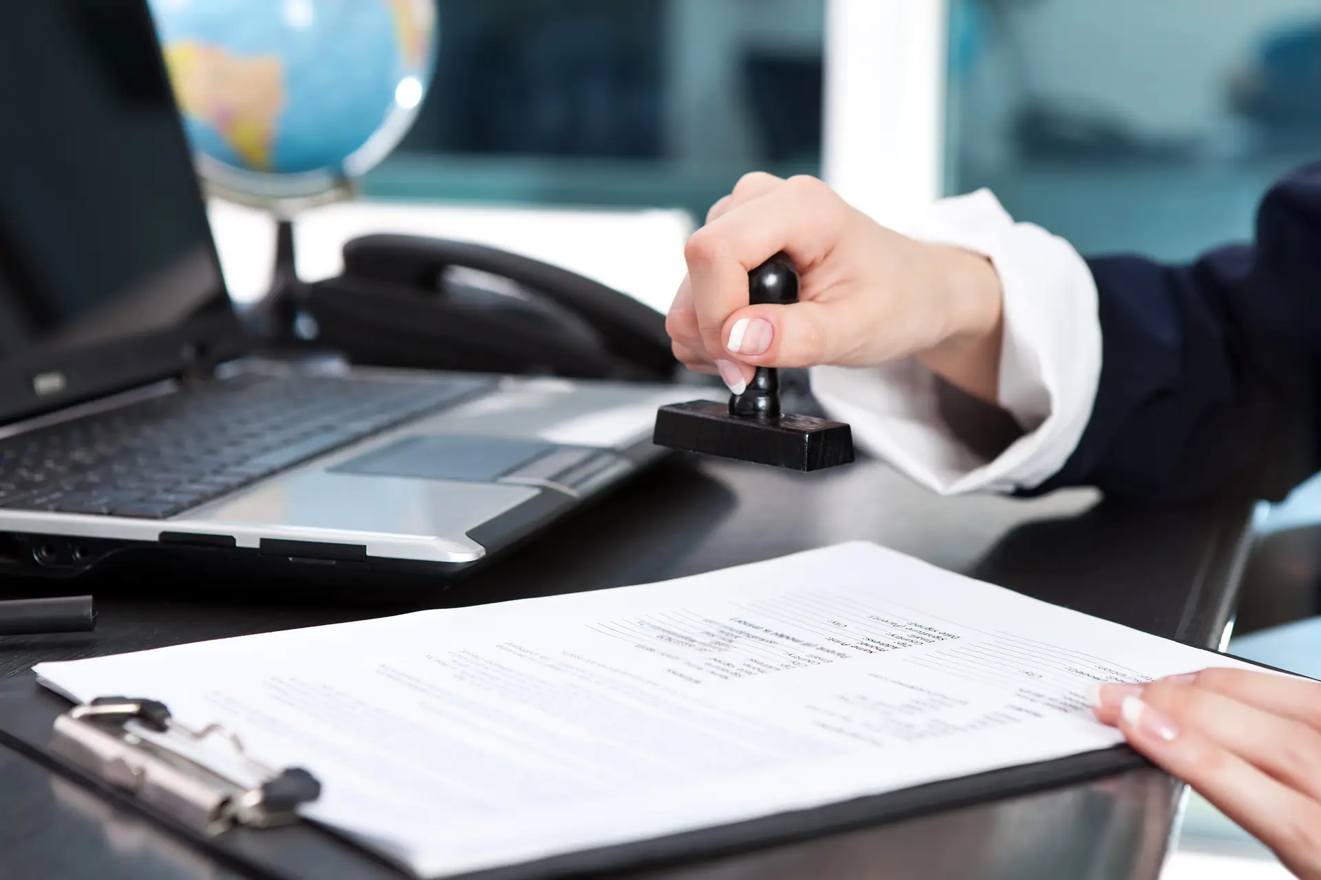 Notary stamping legal document at desk in Hackettstown, NJ