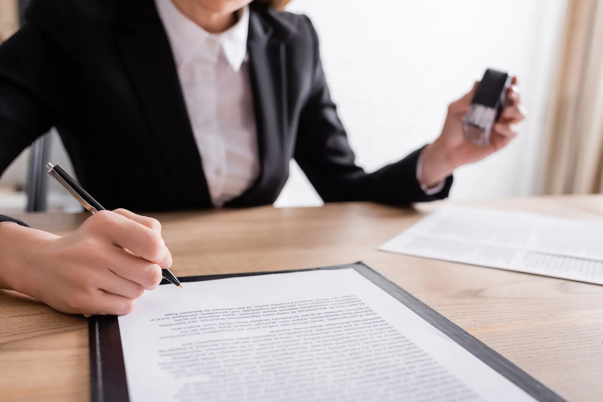 Close-up of notary public signing official documents in Phillipsburg, NJ