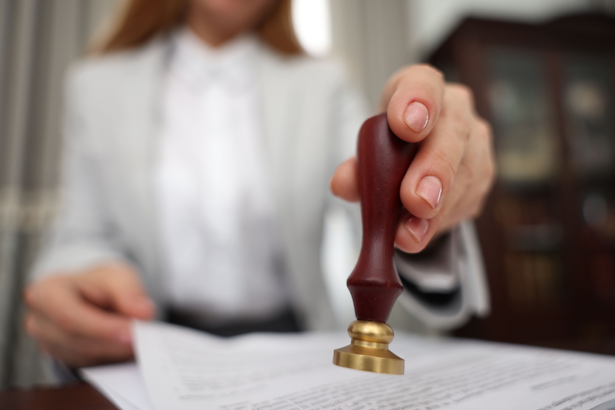 Close-up of a notary public stamping a legal document as part of specialized notary services in New Jersey