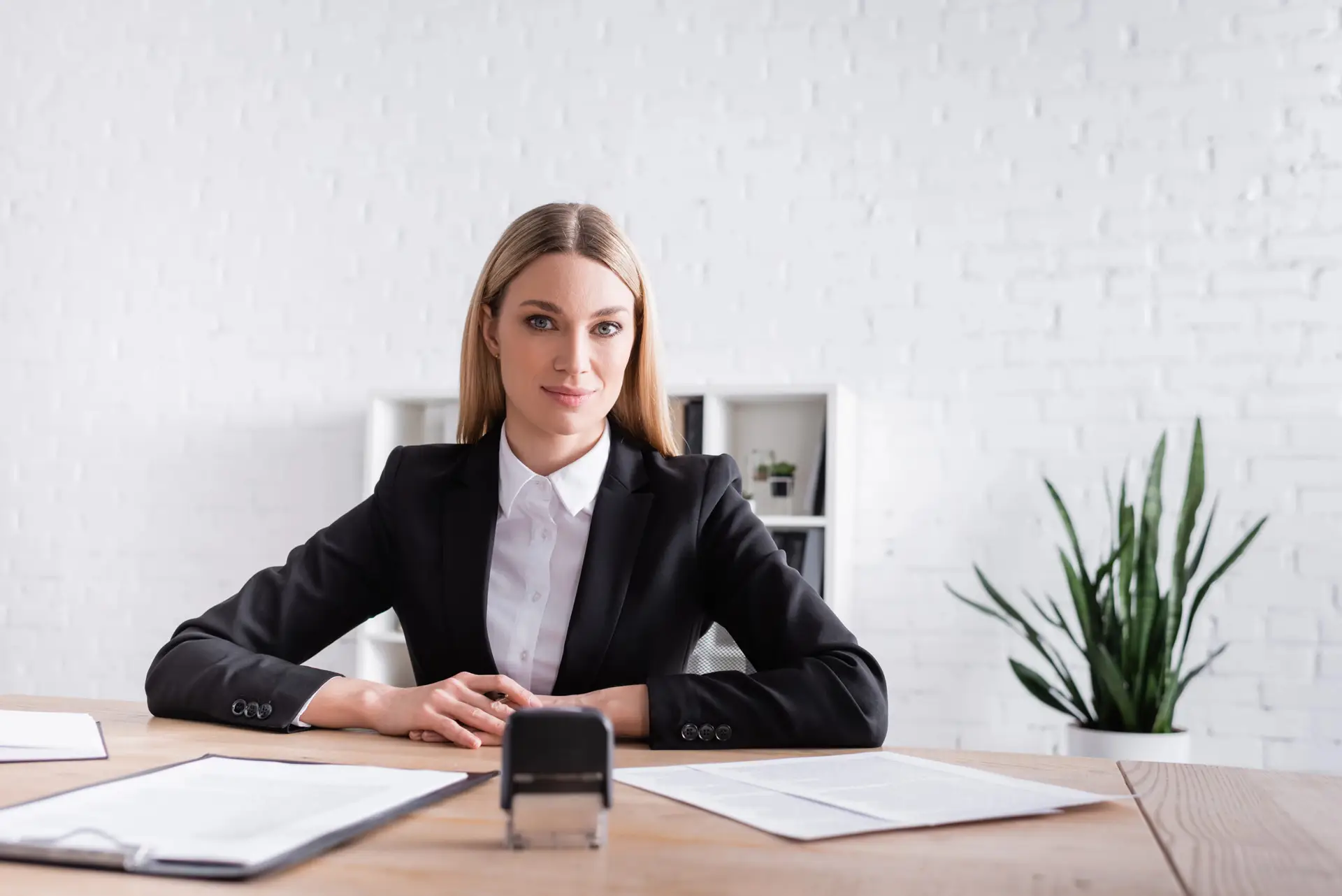 Professional mobile notary in Warren County, NJ sitting at a desk with documents and a notary stamp