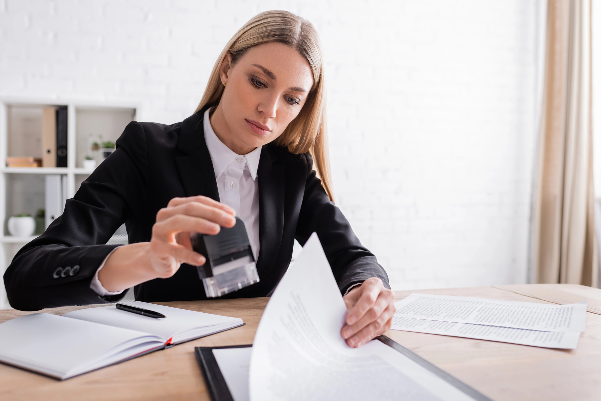 Professional female notary public stamping documents in Warren County, NJ