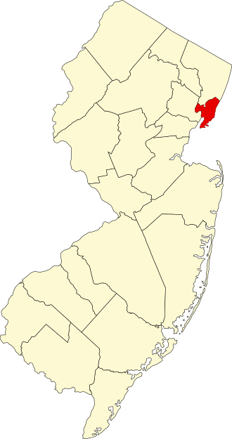 Map of New Jersey with one northeastern county highlighted in red, indicating Hudson County, while the rest of the counties are shaded in light yellow.
