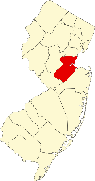 Map of New Jersey with one central county highlighted in red, while the rest of the counties are shown in beige.